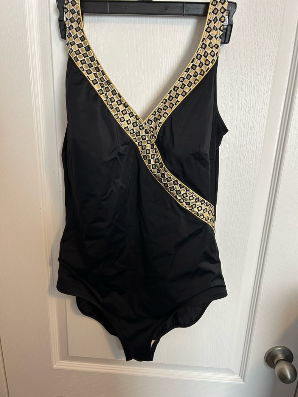 Roxanne brand vintage one-piece swimsuit. features a black body with gold trim